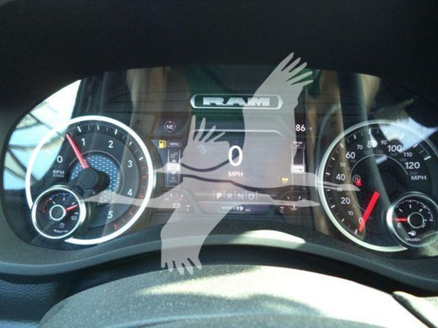 Ram instrument cluster dashboard showing 0 MPH and digital readouts in a new Ram pickup truck.
