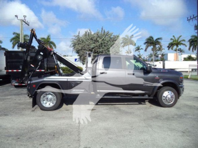Ram 2500/3500 heavy-duty truck in profile with crane/winching equipment mounted in bed, 2026 Ram Big Horn | VIN 3C7WRNEL7TG225602