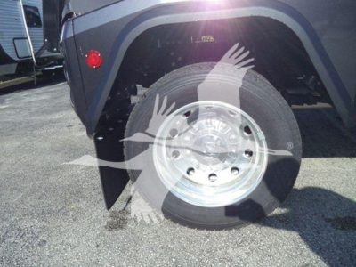 Ram truck wheel and fender view showing polished aluminum wheel and tire with partial fender close-up