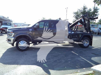 Ram pickup truck showing a winch tow setup in rear with a graphic bird silhouette across the doors.