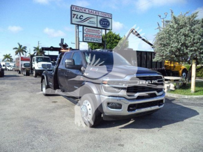Ram 2500/3500 truck in a dealership lot showing front grille and partial crane equipment on bed, RAM emblem visible.
