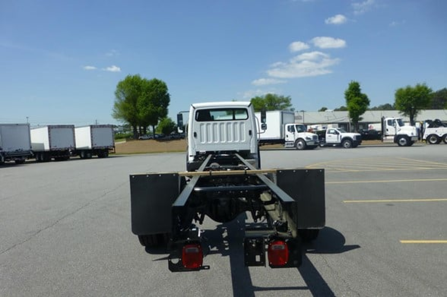 Freightliner Business Class M2 106 Plus cab and chassis rear view showing frame and tail lights.