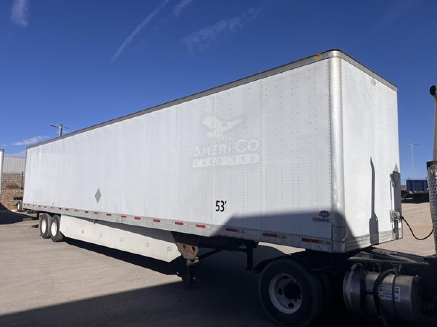 Utility dry van trailer with rear swing doors showing 53' length and AmeriCo trailer logo.
