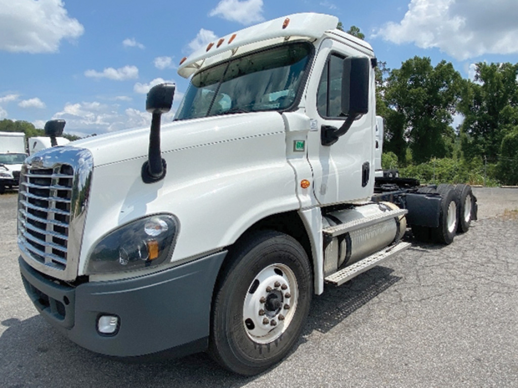 Freightliner Cascadia125 tractor cab side view showing front grille, headlights, mirrors, and wheel with dual rear axles.