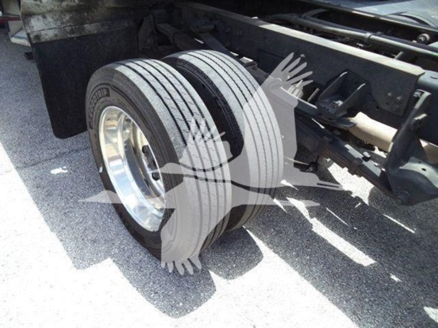 Rear double axle of a Ram truck with dual rear tires and suspension components visible.