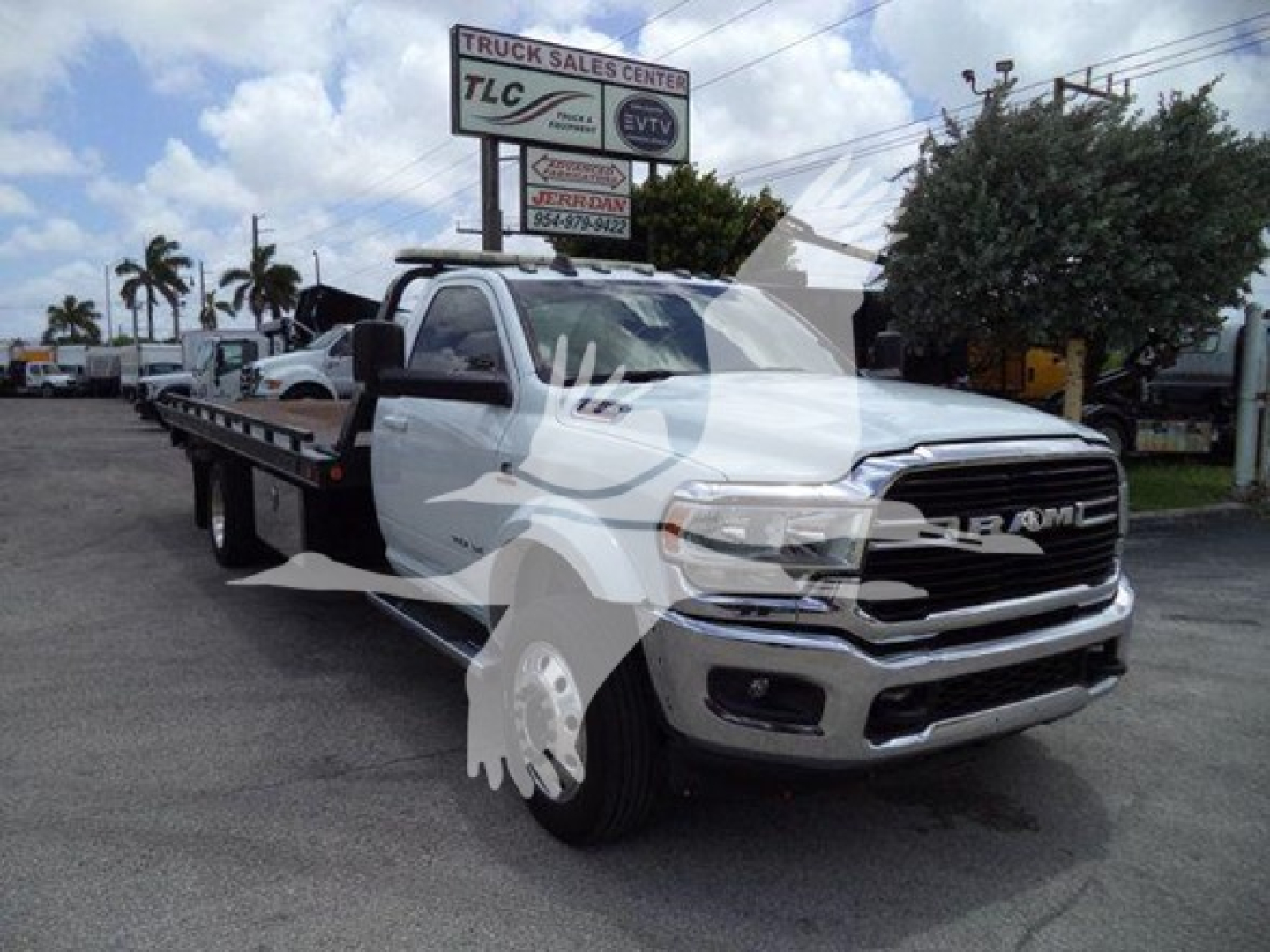 Ram 2021 RAM 5500 rollback tow truck with flatbed showing front grille badging and wheels.
