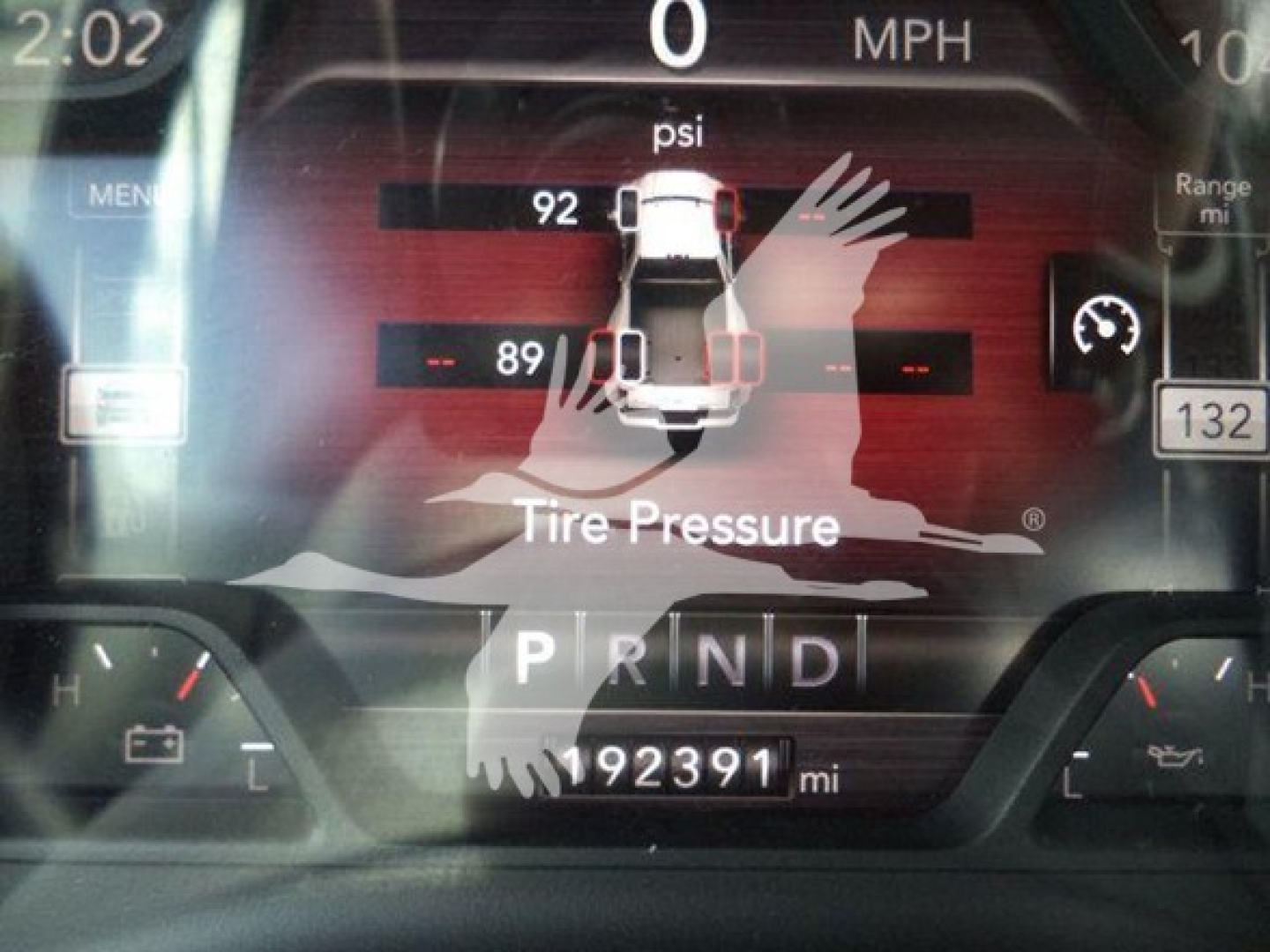 Dashboard display of a 2021 Ram SLT truck showing tire pressure graphical readout and gear indicator P R N D with odometer 192391 miles.