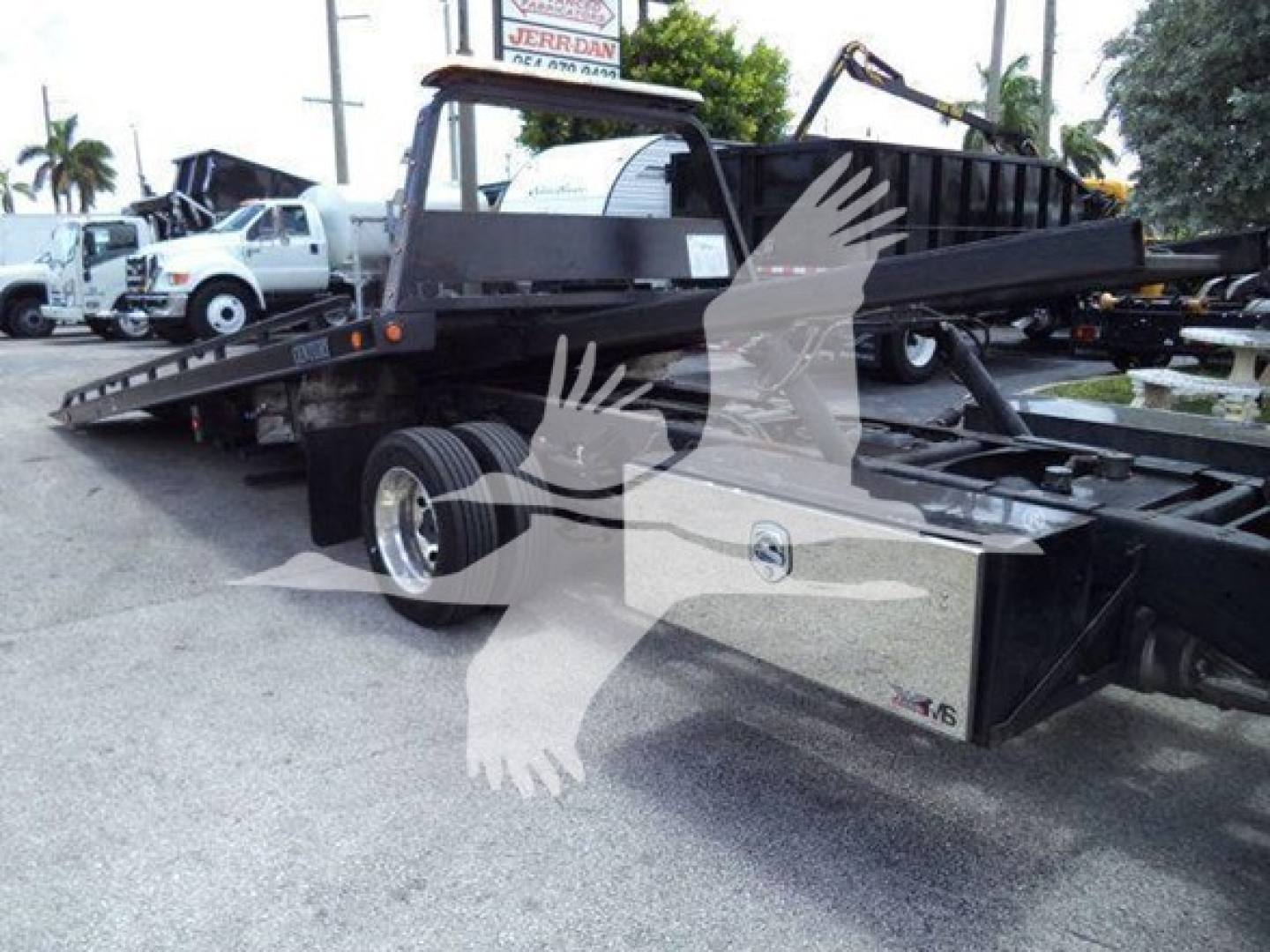 Ram 2021 SLT rollback tow truck with flatbed and hydraulic system showing metal frame and wheels.