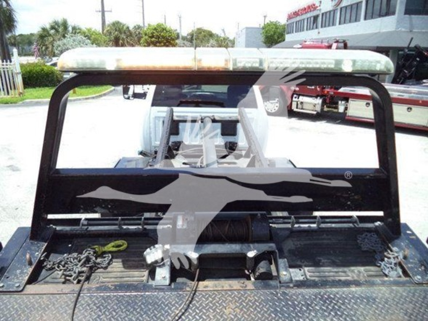 Ram pickup truck rollback bed showing cargo area with rear lights bar and towing equipment in view.