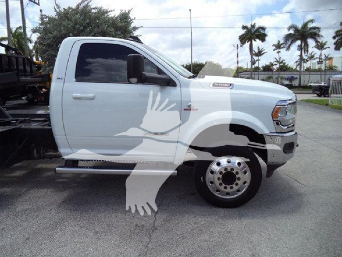 Truck side view showing white Ram 2500/3500 pickup with large bird graphic decal on door and fender, single cab, rollback service truck category.