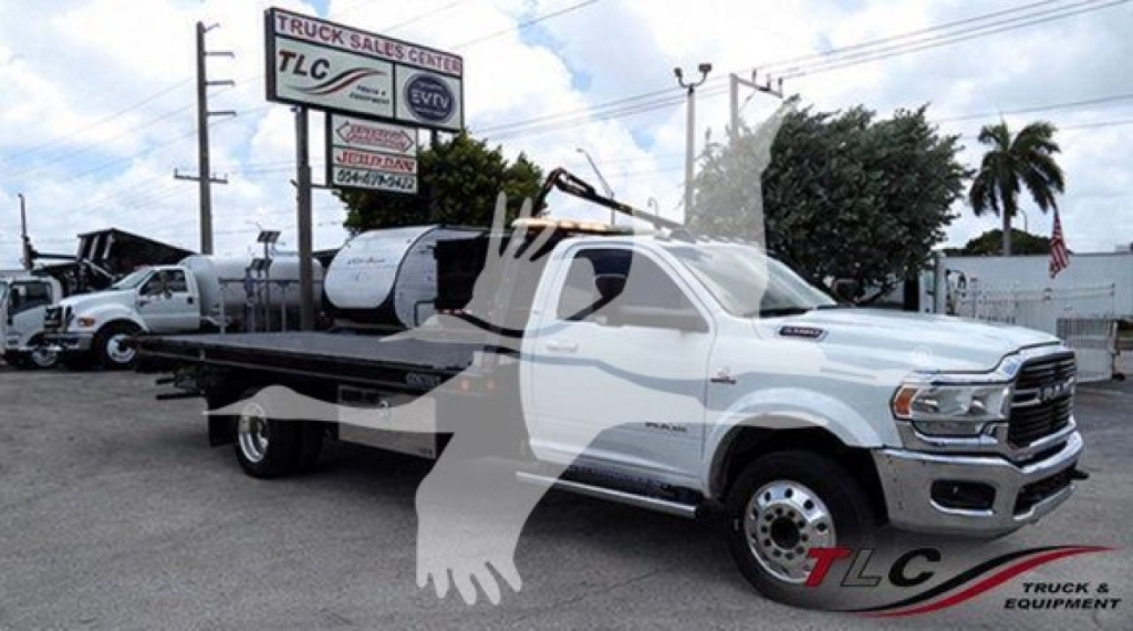 Ram 5500 rollback tow truck in white with flatbed, side view, TLC logo watermark.