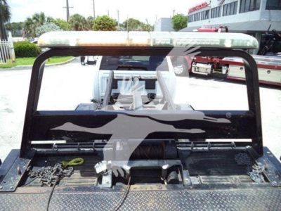 Ram pickup truck rollback bed showing cargo area with rear lights bar and towing equipment in view.