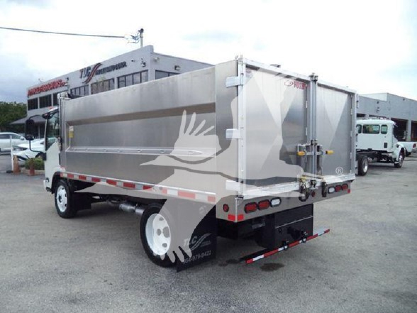 Truck dump bed of a 2017 Chevrolet W4500 with side and rear view showing silver dump body and dual rear doors.