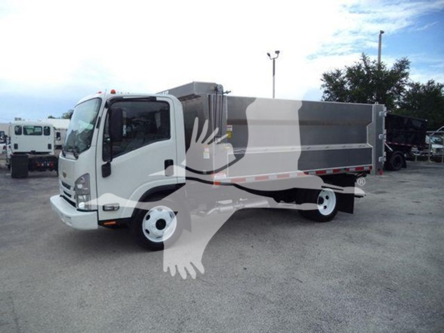 Dump truck body on a 2017 Chevrolet W4500 with a gray dump bed, side view showing cargo bed and front cab.