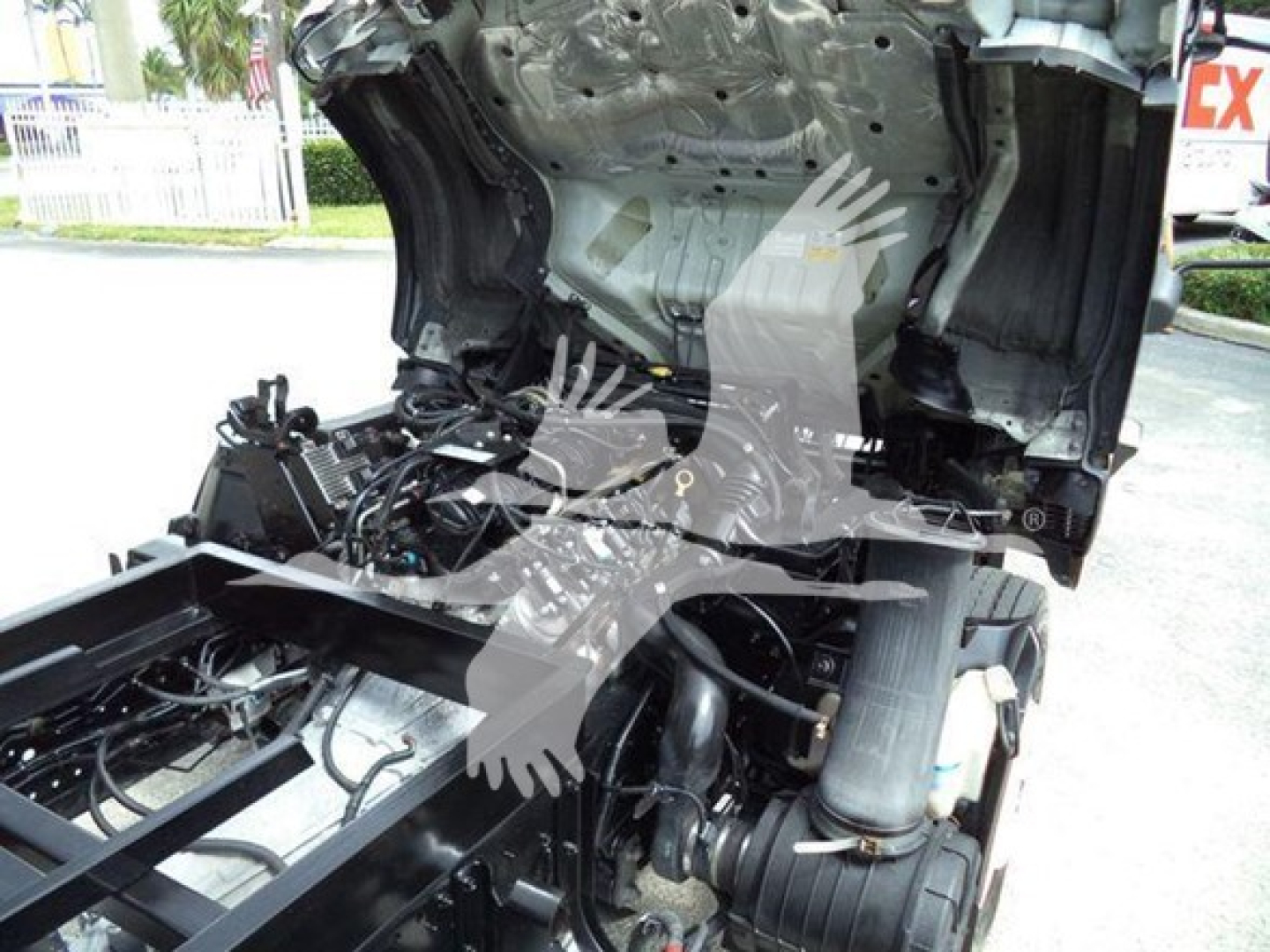 Chevrolet W4500 cab-forward chassis area showing engine bay access with exposed frame and wiring; partial view of firewall and exhaust system.