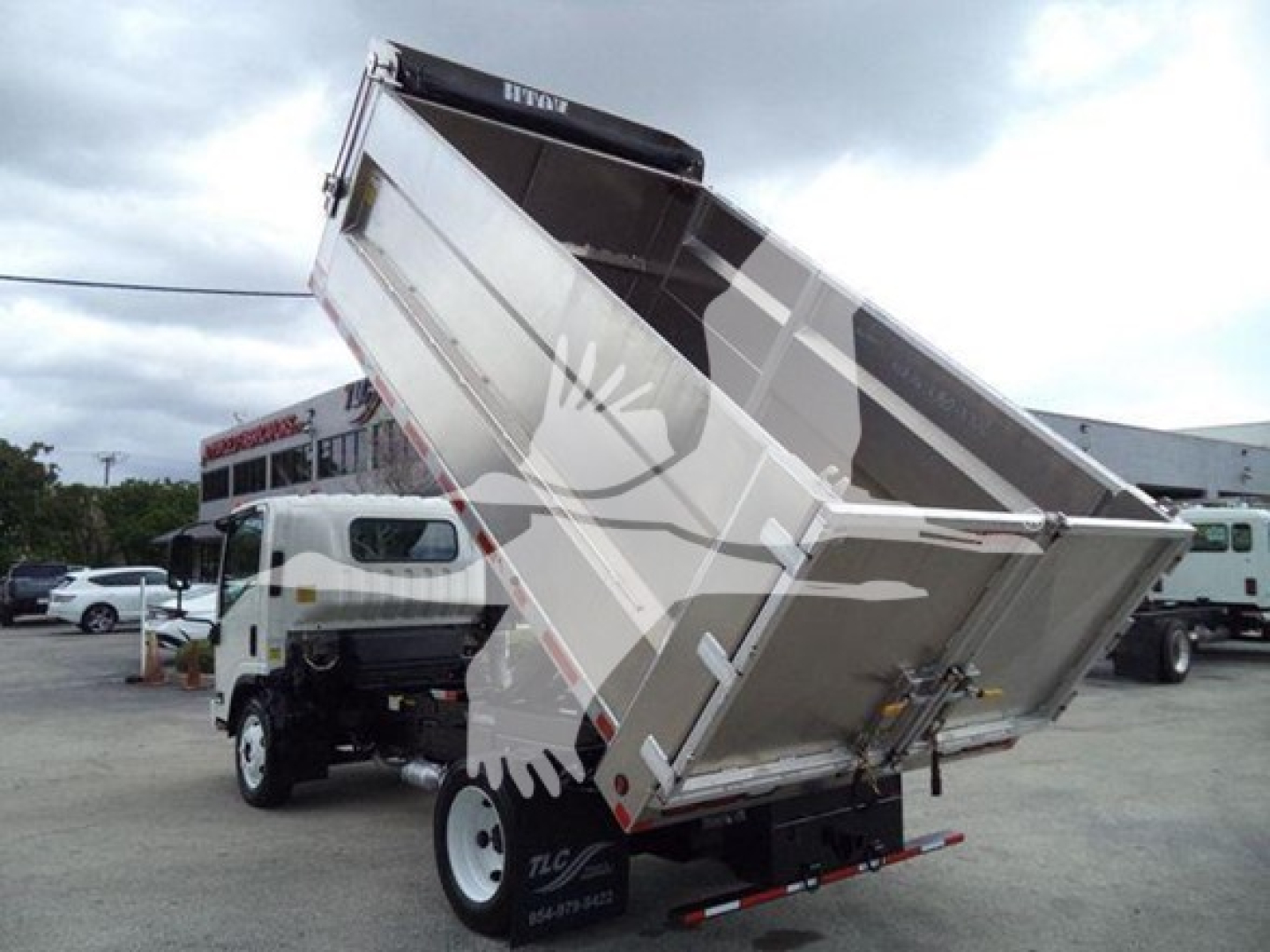 Chevrolet W4500 dump truck bed raised showing cargo bed with hydraulic lift and rear lights.