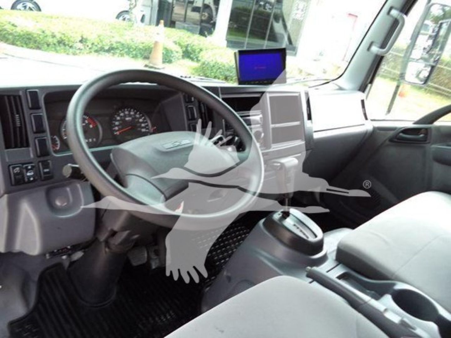 Cab interior of a 2017 Chevrolet W4500 dump truck showing steering wheel, dashboard, center console, and a mounted tablet screen.