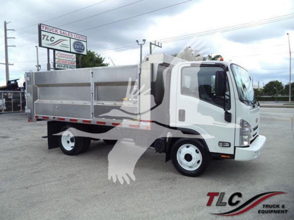 Dump truck showing side of cargo bed and cab; TLC Truck & Equipment logo watermark; white body with aluminum dump bed.