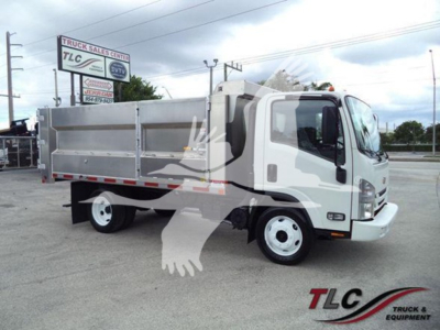 Dump truck showing side of cargo bed and cab; TLC Truck & Equipment logo watermark; white body with aluminum dump bed.