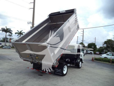 Rear and left side view of a Chevrolet W4500 dump truck with the bed raised. Visible text includes stock/tel numbers on the bed and small decals on the rear bumper.