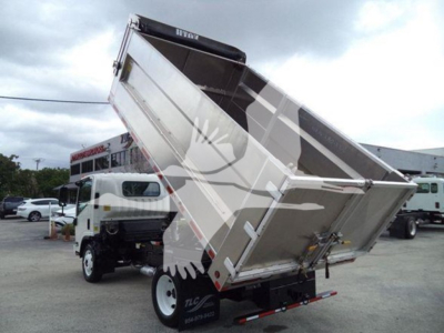 Chevrolet W4500 dump truck bed raised showing cargo bed with hydraulic lift and rear lights.