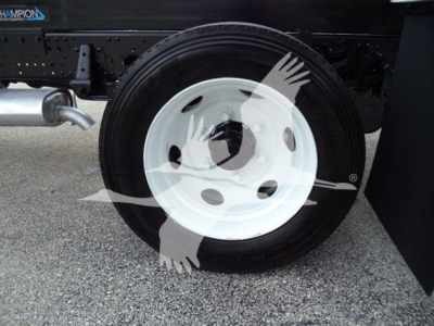 Chevrolet W4500 wheel and tire assembly on dump truck chassis showing white steel wheel with black tire.
