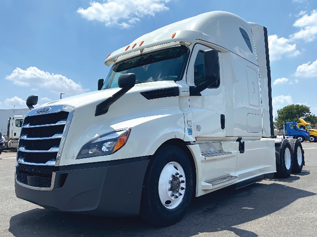 Freightliner Cascadia126 tractor in white side view showing cab and front grille with aerodynamic mirrors.