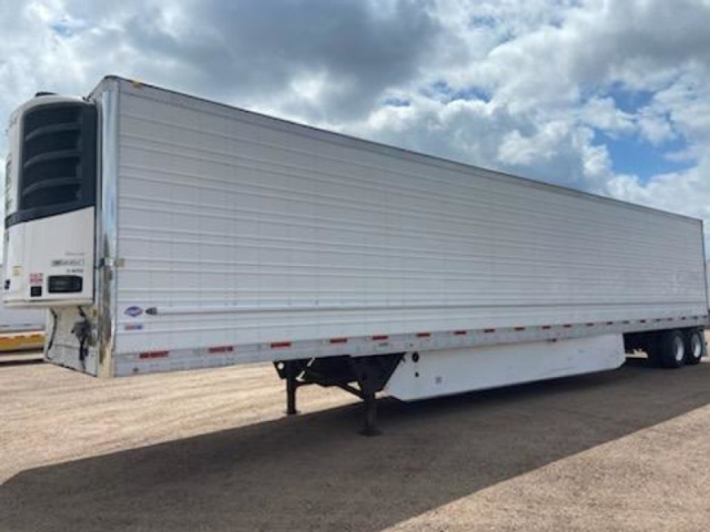 Reefer trailer in side view with white exterior and rear refrigeration unit, undercarriage visible, stock number U91014.