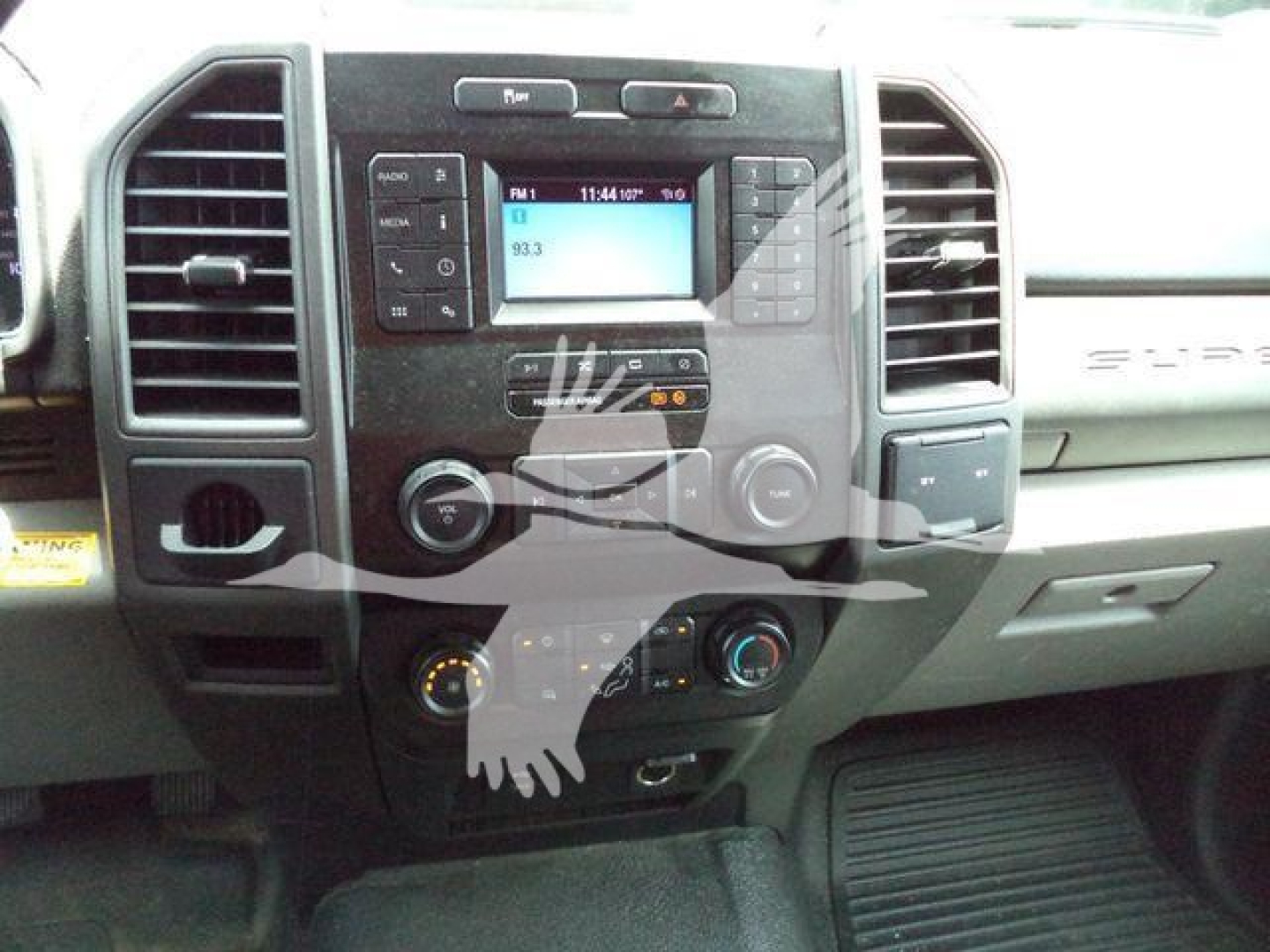 Dashboard area of a Ford F-550 cab showing center infotainment display, climate controls, and vents.