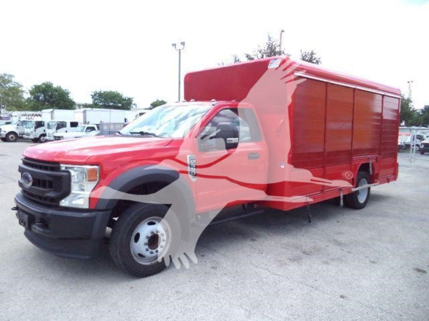 Ford F-550 utility truck in red with box cargo, side view showing cab and cargo area.