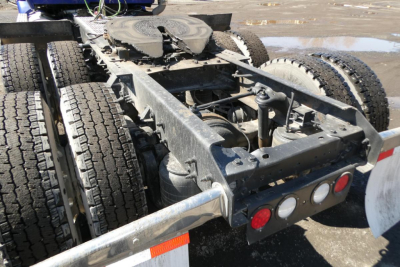 Kenworth T680 chassis and fifth wheel area showing dual rear axles and frame with suspension components.