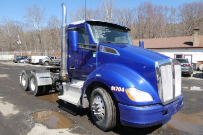 Kenworth T680 conventional daycab tractor in blue, side view showing chrome exhaust stack, cab steps, and front grille; numbers 81704 on door and windshield text visible.