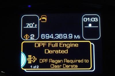 Kenworth T680 instrument cluster display showing mileage 694,369.9 miles and 70°F outside temperature with DPF Full Engine Derated warning message.
