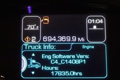 Instrument cluster display showing engine software version C4_C1408P1, hours 17835.0hrs, mileage 694,369.9 Mi, ambient 70°F, time 01:04, indicators, truck icon.
