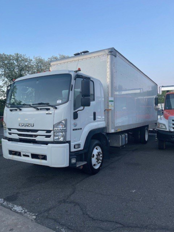 Isuzu box truck with white cab and large refrigerated box, front grille shows ISUZU badge. Side view shows cargo area, no legible serials visible.