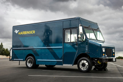 Harbinger S534 step van in blue with Harbinger logo and yellow text on side, side-view showing cargo area and front wheel.