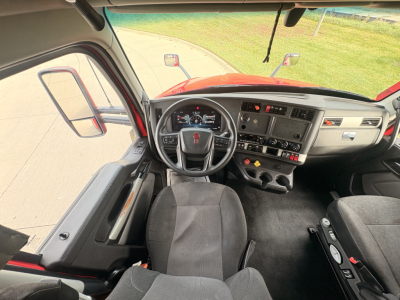 Kenworth T680 truck interior view from driver seat showing steering wheel, dashboard, and center console with gauges and controls.