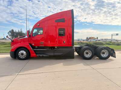 Kenworth T680 sleeper cab truck side profile showing red exterior, dual rear axles, and chrome fuel tanks with black undercarriage.