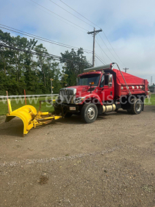 Truck-mounted plow setup on a red 2008 International 7400 with yellow plow attachment.
