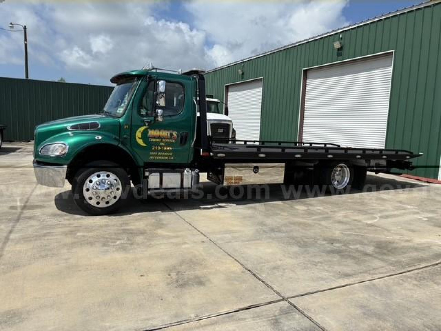 Tow truck 2017 Freightliner M2 106 side view with flatbed, green cab, stock number 22783-201, VIN 1FVACWDT1HHHV4869 visible on listing image.