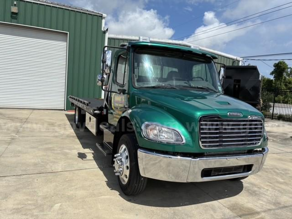 Vehicle image showing a green 2017 Freightliner M2 106 tow truck front-left view with chrome bumper and flatbed.