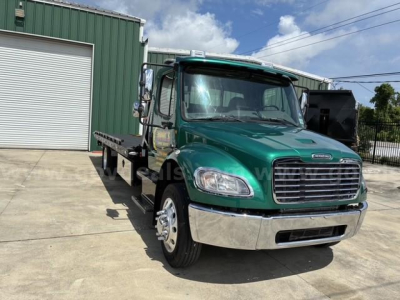 Vehicle image showing a green 2017 Freightliner M2 106 tow truck front-left view with chrome bumper and flatbed.