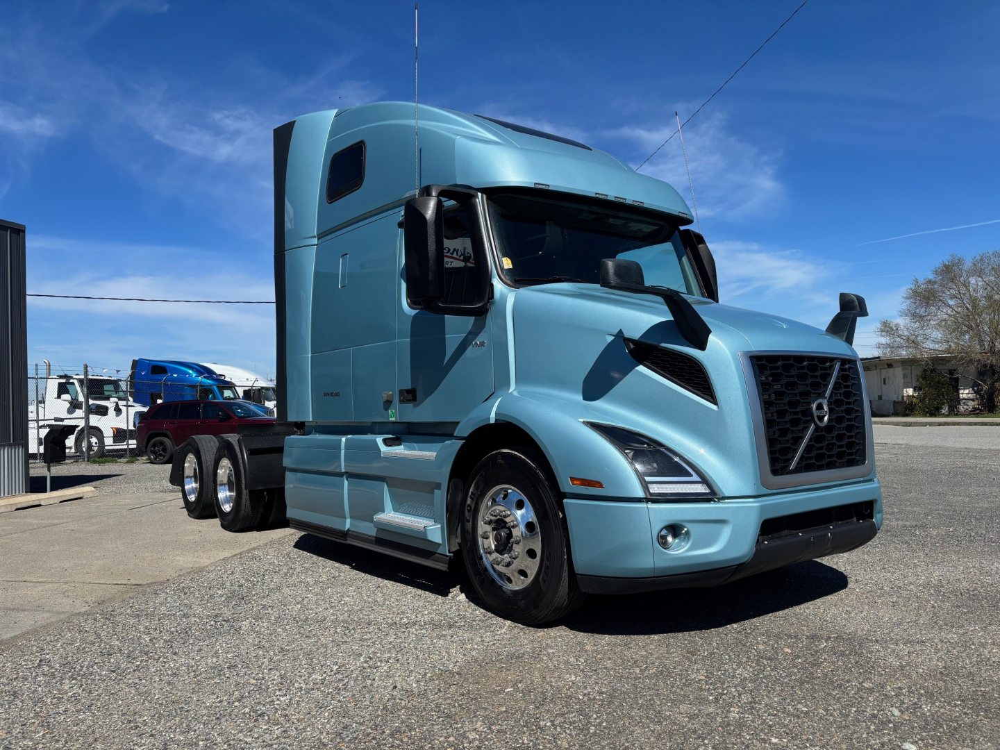 Volvo VNR64T660 sleeper cab truck in blue with large grille and aerodynamic profile.