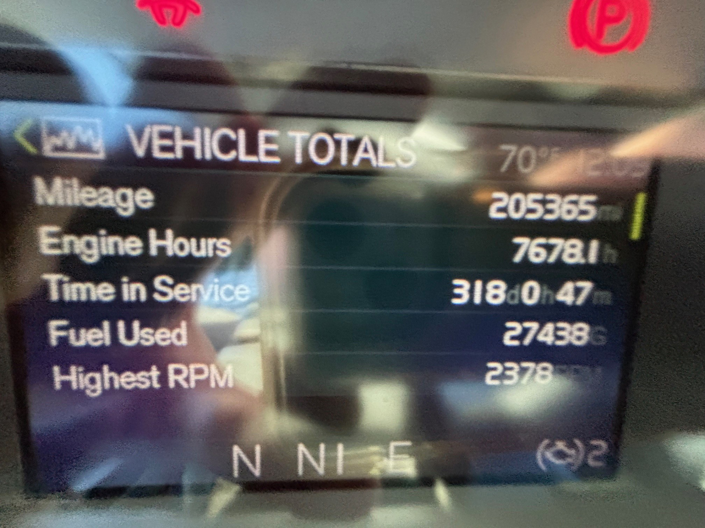 Dashboard display showing Vehicle Totals: Mileage 205365, Engine Hours 7678.1, Time in Service 3180h 47m, Fuel Used 2743.8, Highest RPM 2378. Display includes N N I E letters and warning icons.