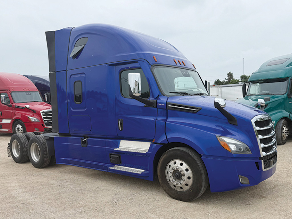 Blue Freightliner Cascadia126 tractor-trailer cab, view of passenger side, shows door, side mirror, chrome steps, and dual rear axles; no visible text on cab.