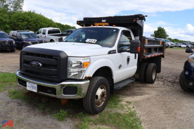 Ford F-350 Super Duty dump truck in a yard showing front and side view with dump bed