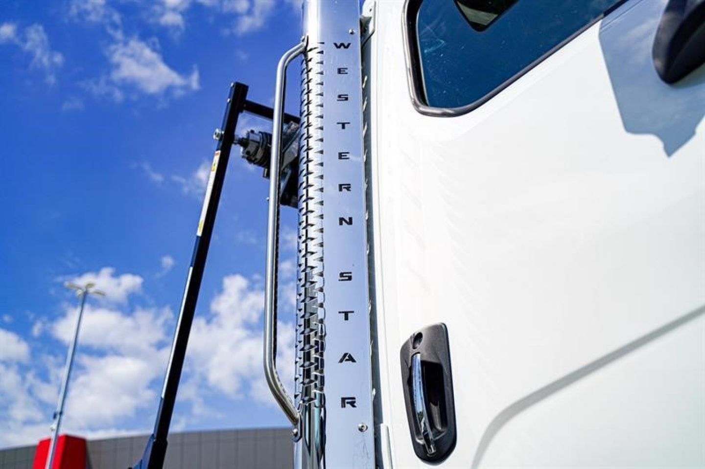 Western Star 47X truck cab vertical chrome door pillar with WESTER N STAR lettering visible.
