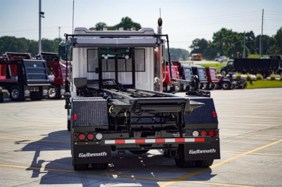 Vehicle rear view showing Exothera (Exhaust?) brand components and roll-off chassis on a new Western Star 47X truck bed.