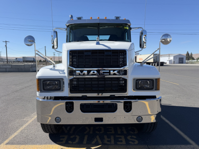 Mack PI84T conventional daycab front view showing large grille with MACK lettering and chrome bumper; headlights and mirrors visible.