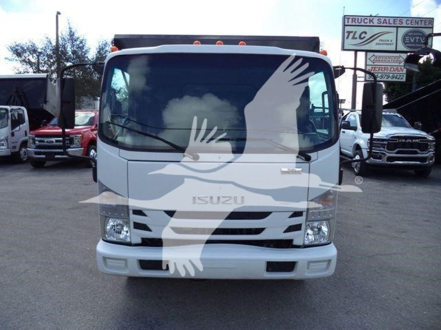 Isuzu NPR/NRR cab front view with large windshield and grille; dealership logo watermark across center.